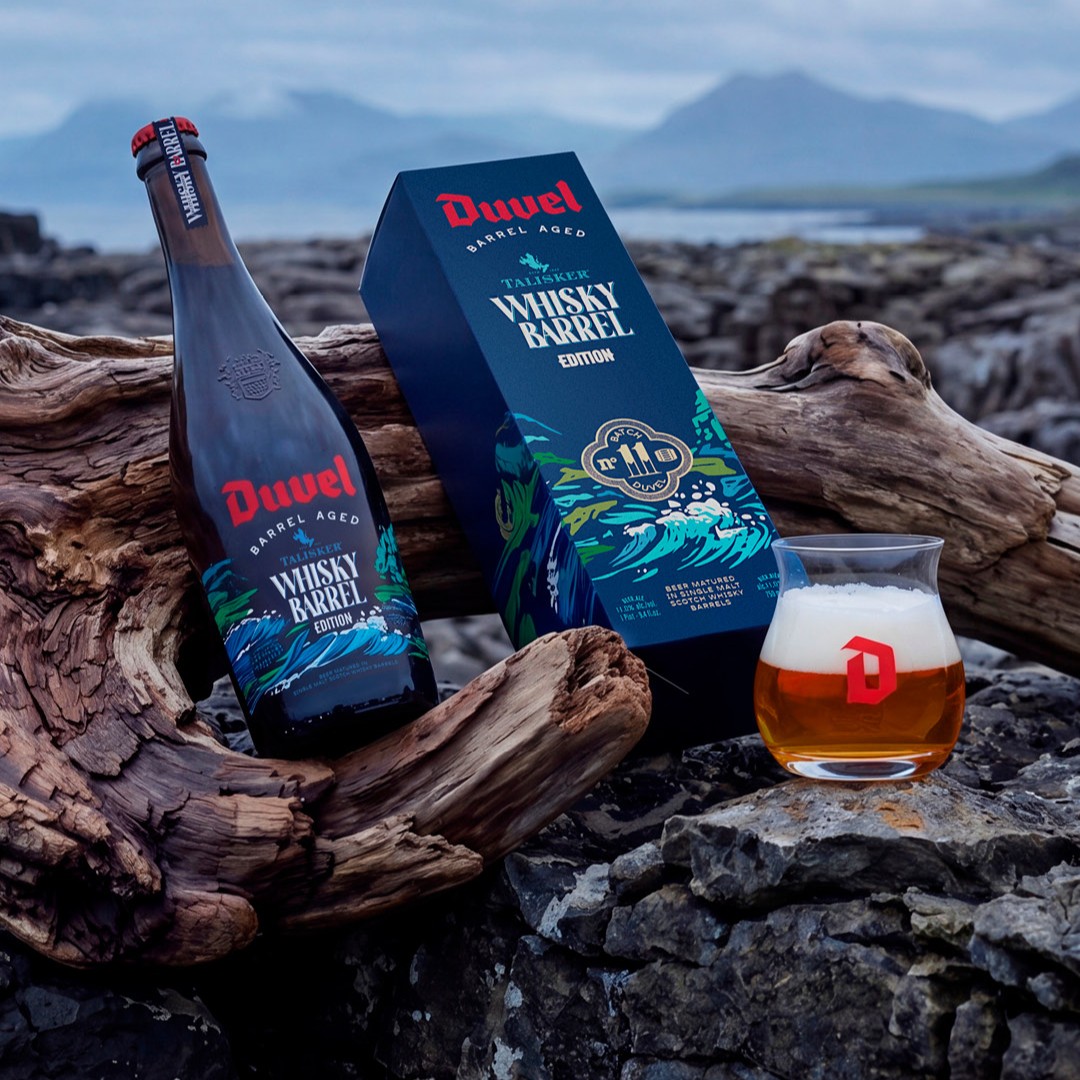 Duvel Barrel Aged Talisker Whisky fles, geschenkdoos en glas op de rotsen